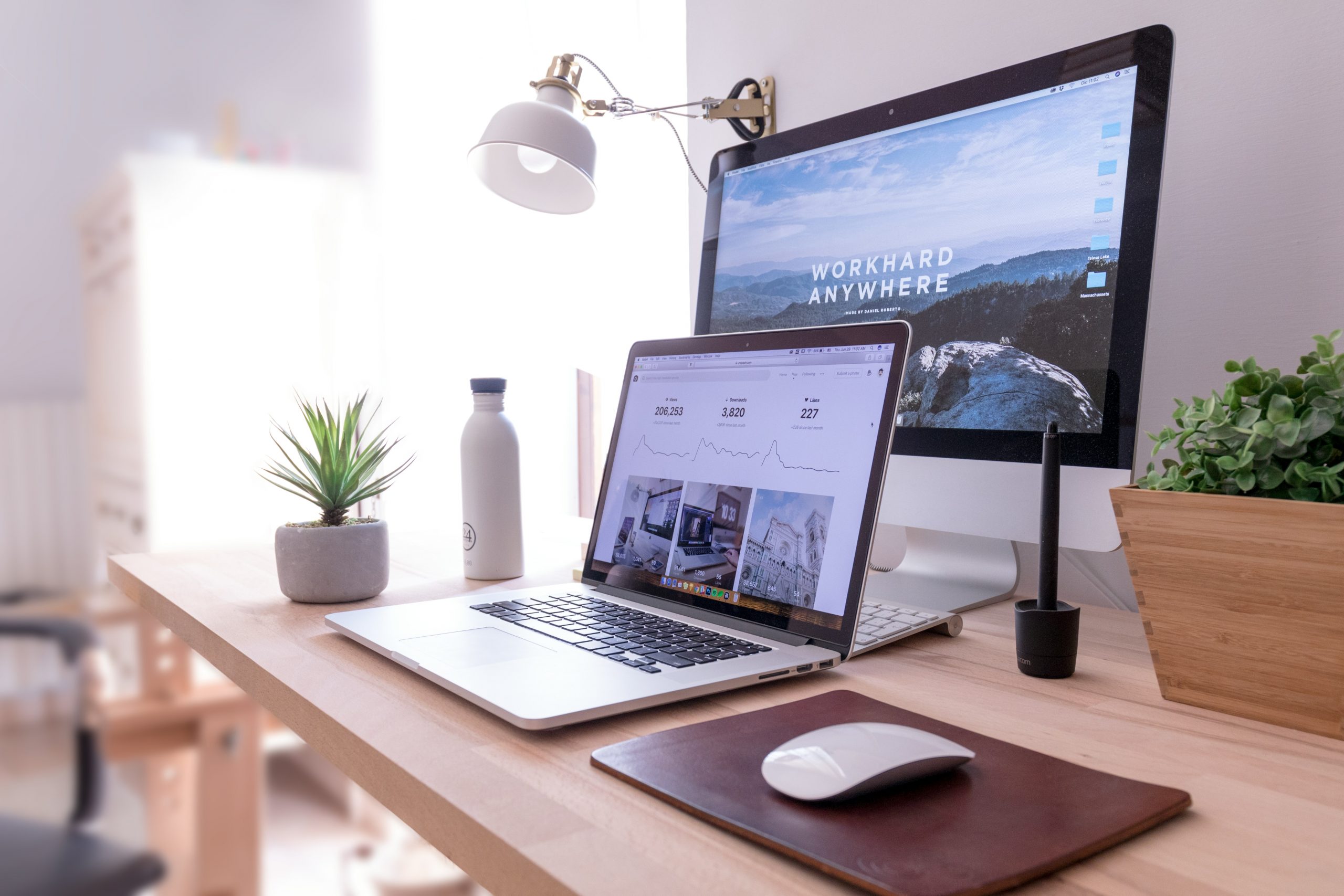 Modern and stylish home office desk with laptop computer and dual monitor setup